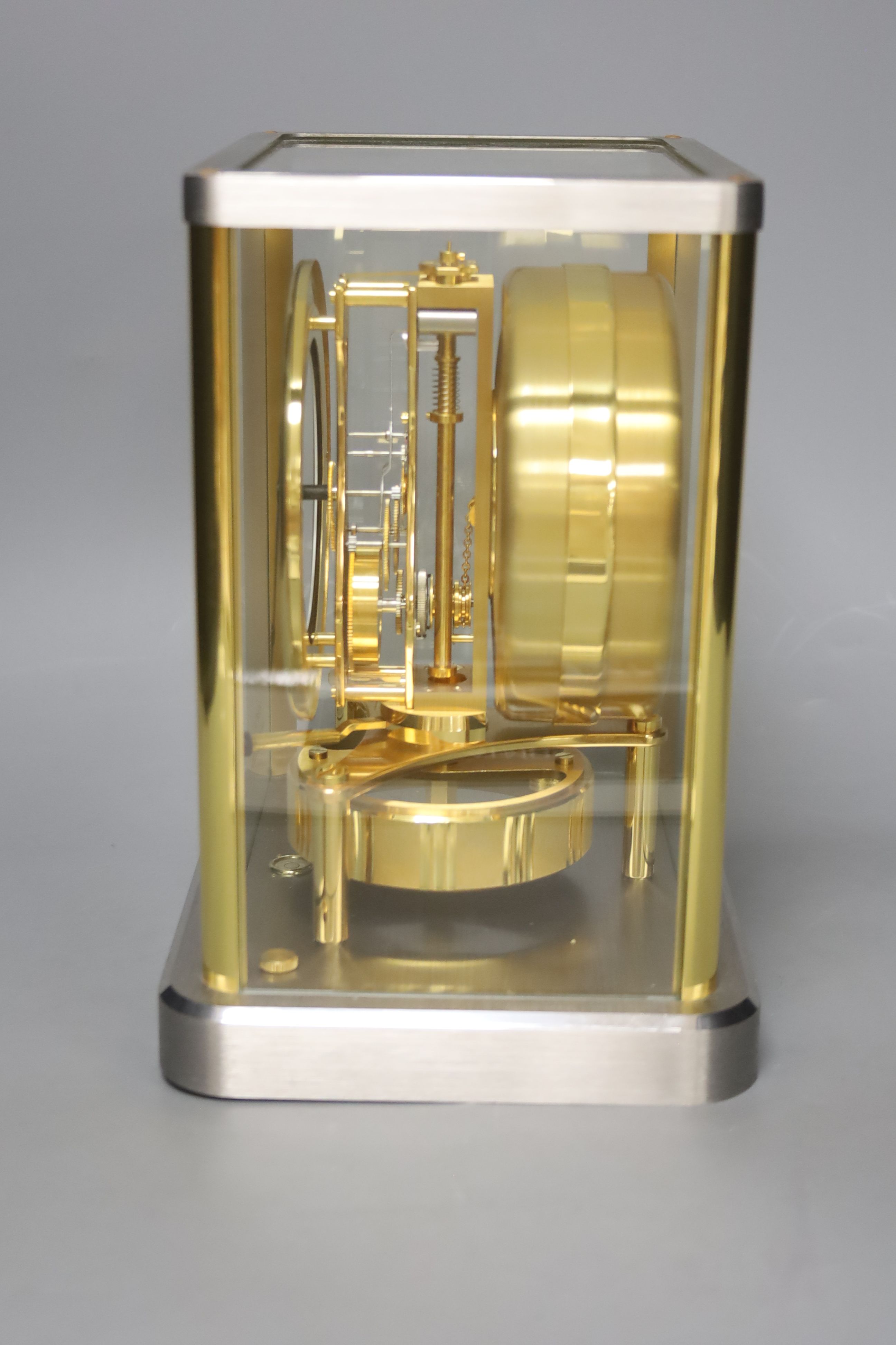 A Jaeger le Coultre Atmos mantel clock, in silvered and gilt metal glazed panelled case, height 23cm